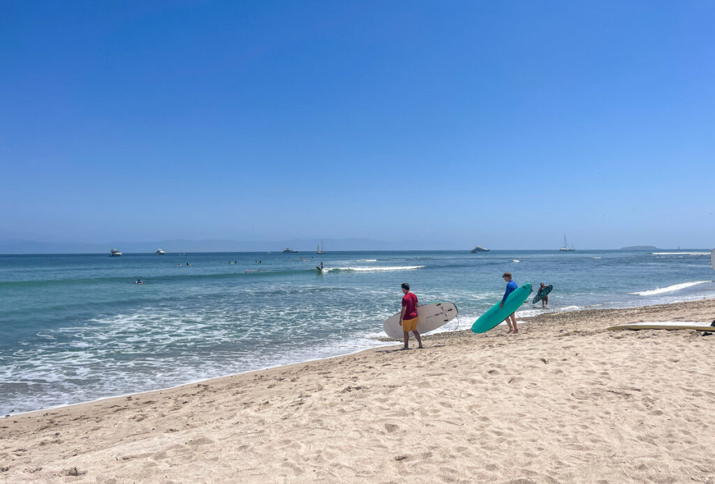 surfers on beach surfing in puerto vallarta