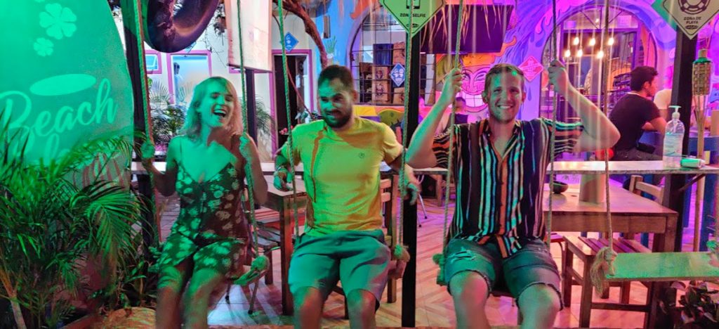 three friends swinging at aloha bars in puerto vallarta