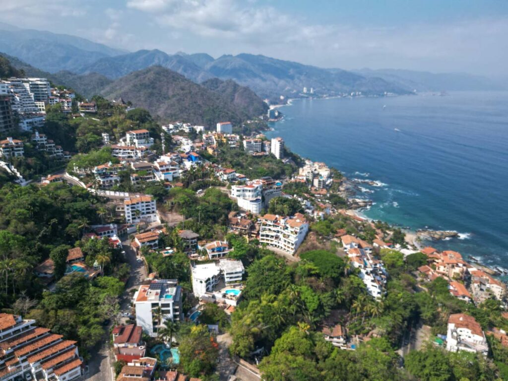 drone shot of the southern beaches of puerto vallarta. ocean meets the city.
