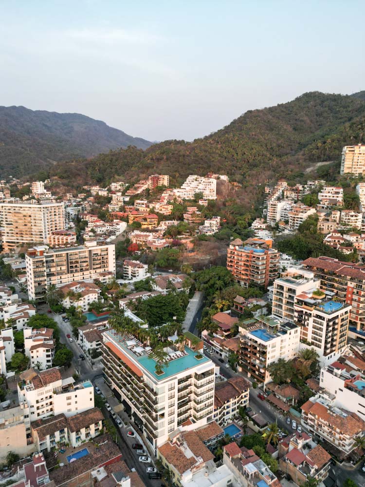 An aerial view of the city of Puerto Vallarta, showcasing its stunning coastline and vibrant urban landscape.