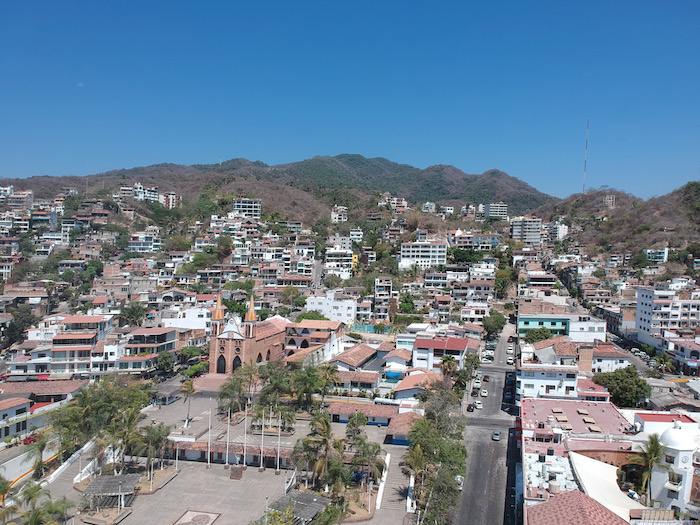 drone photo of Plaza Hidalgo showing church, streets, and houses in Puerto Vallarta