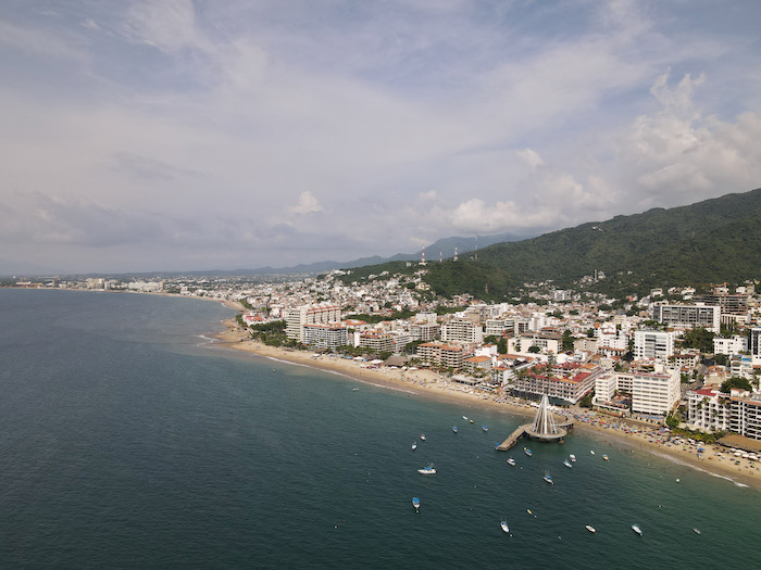 aerial shot of Puerto Vallarta Romantic Zone. beach and ocean with city in backdrop.