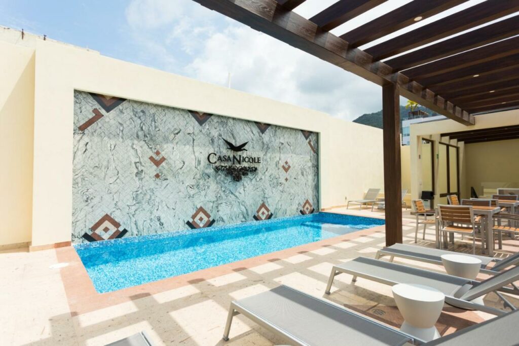 casa nicole pool with sun loungers around it