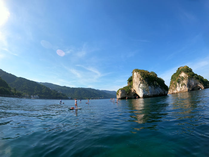 tourists on paddleboards going towards los arcos