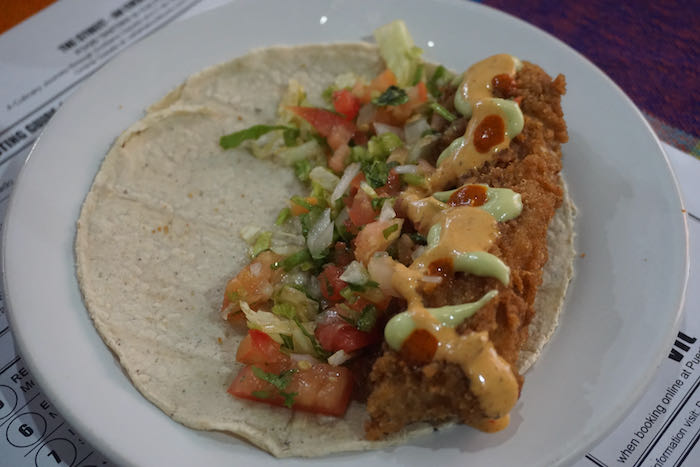 Fried fish taco on a white plate in mexico