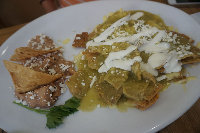 Chilaquiles on a white plate at Fredy's Tucan while having breakfast in Puerto Vallarta