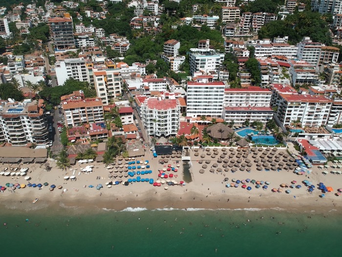 aerial view of Los Muertos Beach. you can see the many hotels and restaurants that line the beach and the busy nature.