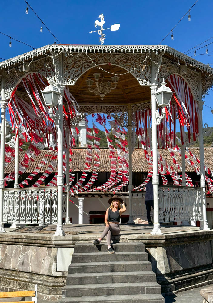 lora sitting in main square of san sebastian with colorful flags around