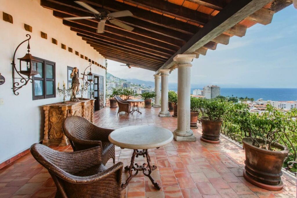 patio furniture on balcony overlooking ocean at hacienda san angel