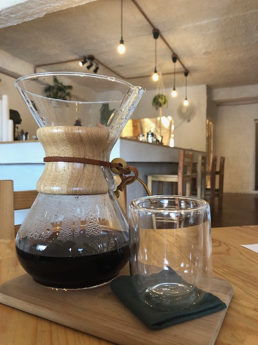 A Chemex coffee brewer stands proudly on a counter, ready to brew a delicious cup of coffee