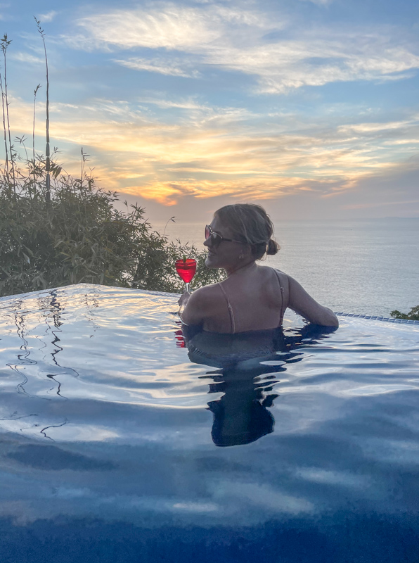 lora smiling in pool holding a drink in puerto vallarta