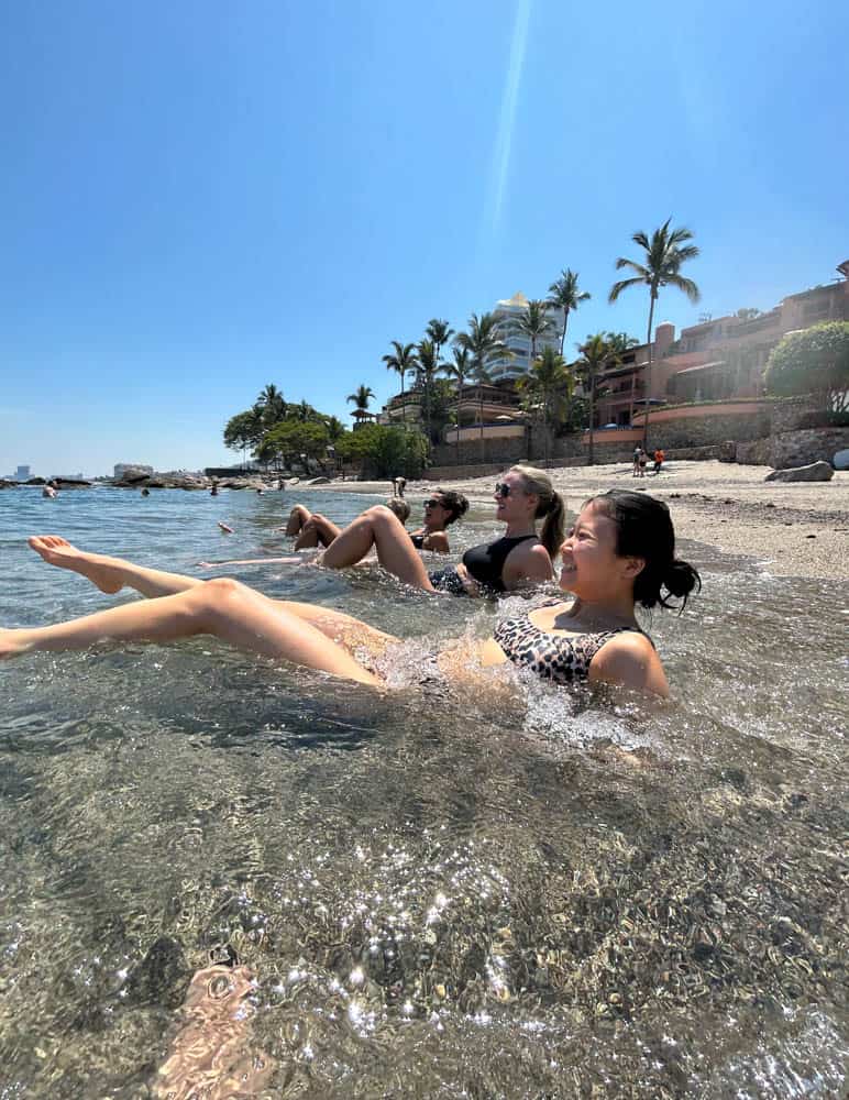four girls swimming in playa conchas chinas