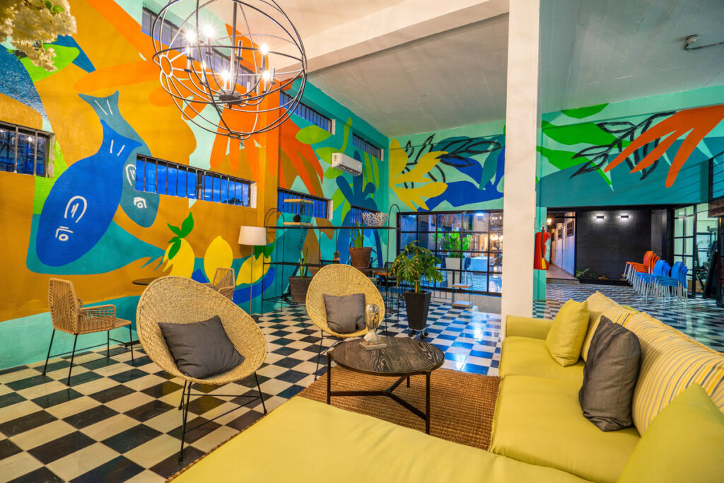 yellow couch and brightly painted walls at Joint cowork puerto vallarta