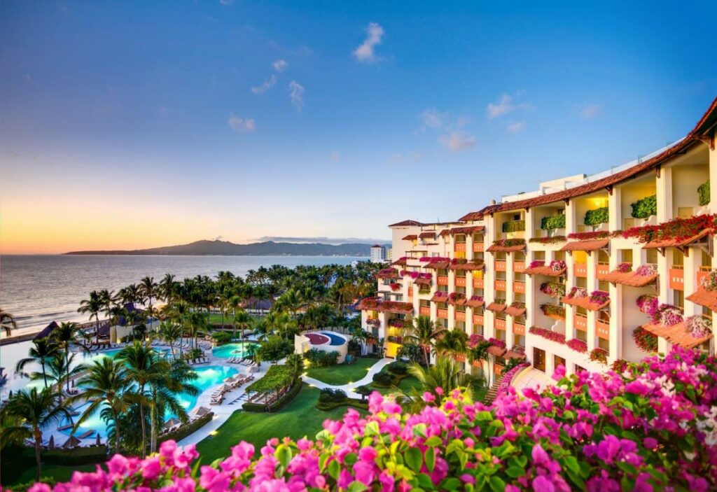 hotel with pink flowers overlooking ocean