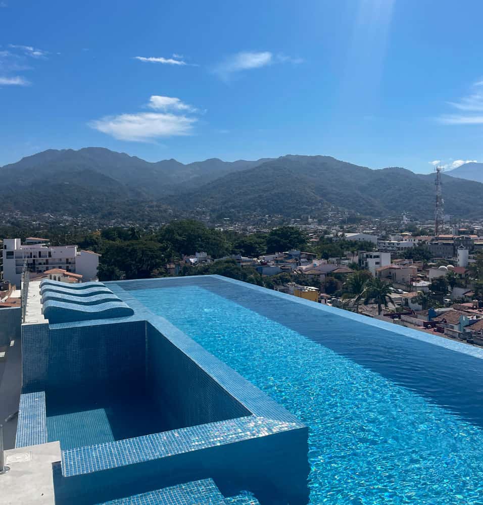  rooftop pool with majestic mountains serving as a breathtaking backdrop in versalles puerto vallarta