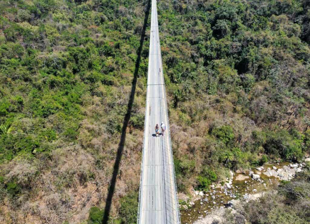 A breathtaking aerial view of the iconic Jorullo Suspension Bridge, spanning the picturesque Jorullo Canyon, showcasing its impressive architectural design and scenic beauty