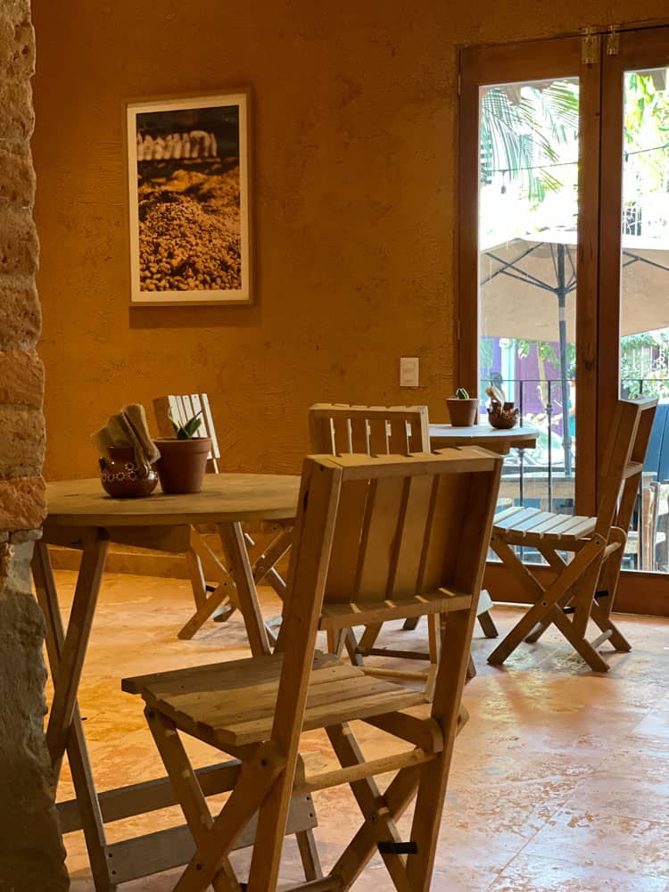 wooden chairs and tables inside cafe la ventana
