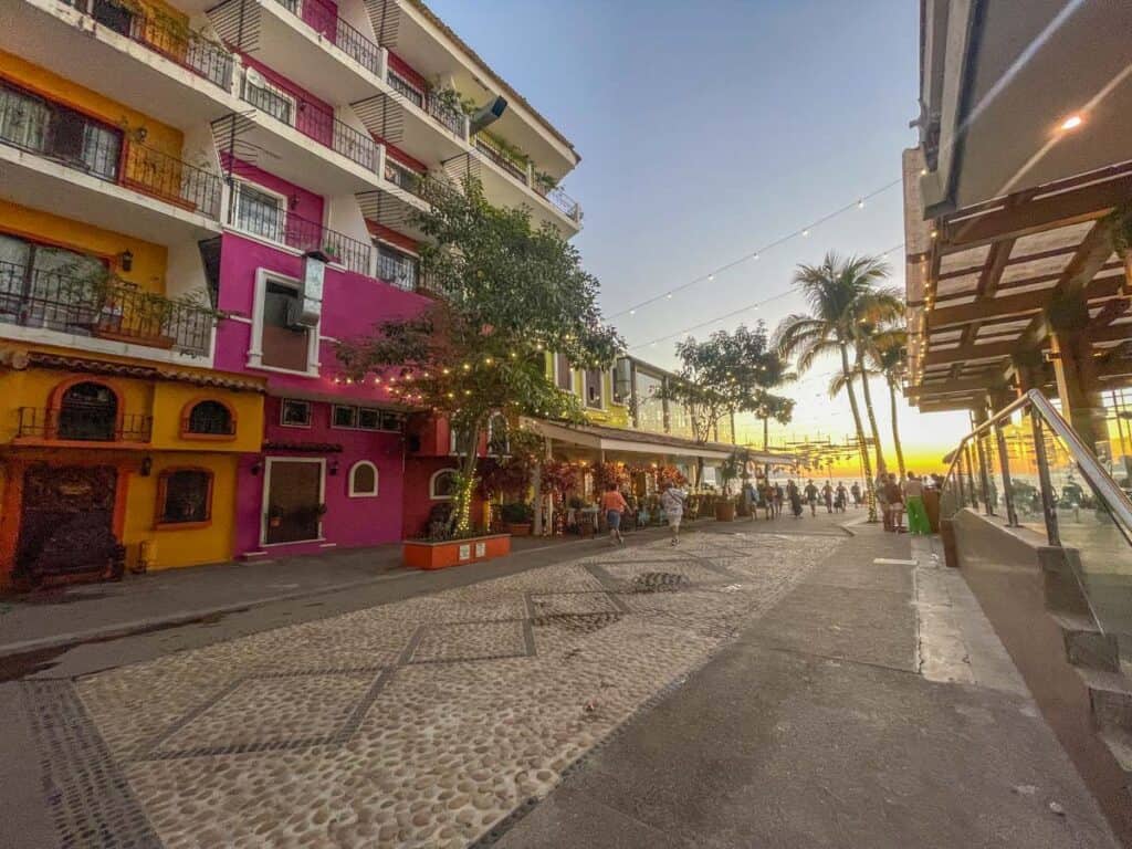 A vibrant street featuring colorful buildings, perfect for Puerto Vallarta Instagram spots.