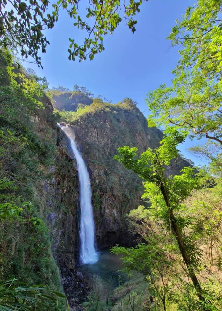 mismaloya waterfall in puerto vallarta. a cascading waterfalls flows down the rocks into the jungle.