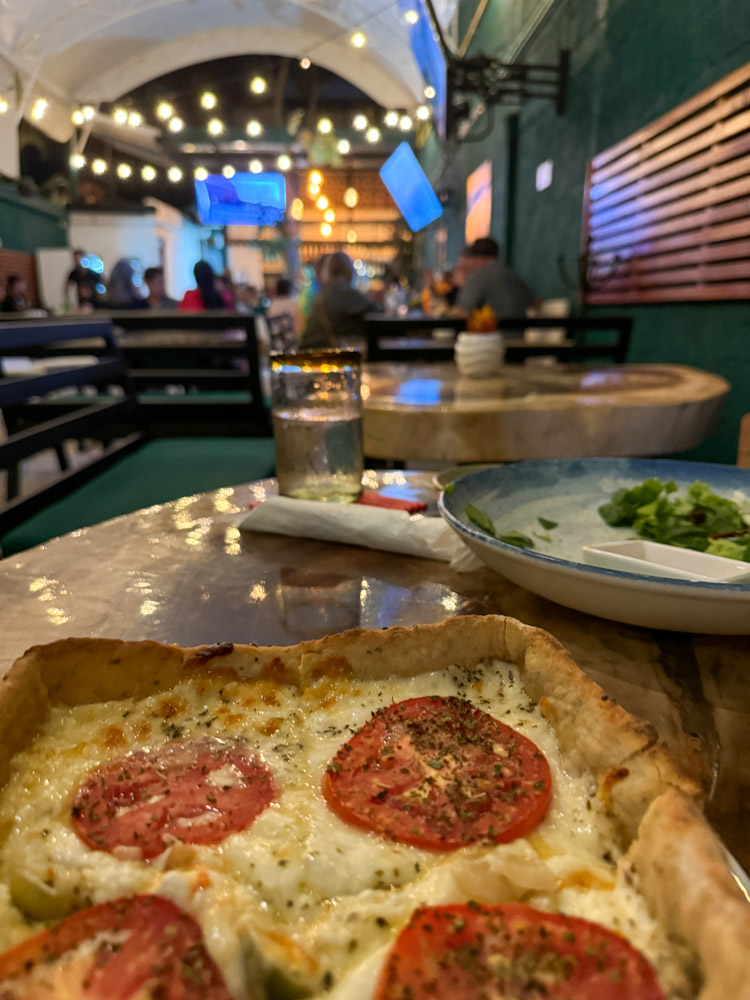 a deep dish pizza on a restaurant table